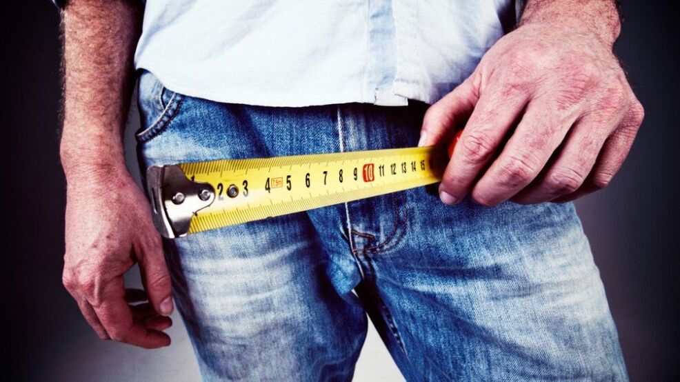man measures his penis after gel enlargement