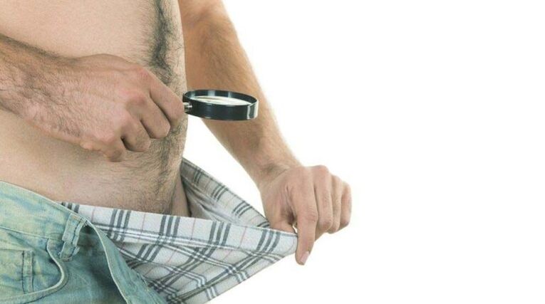 a man looks into his underpants and thinks about enlarging his penis with soda